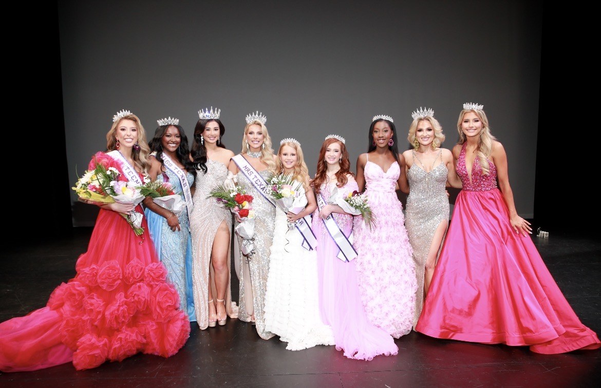 Texas International titleholders in crowns and evening gowns together on stage